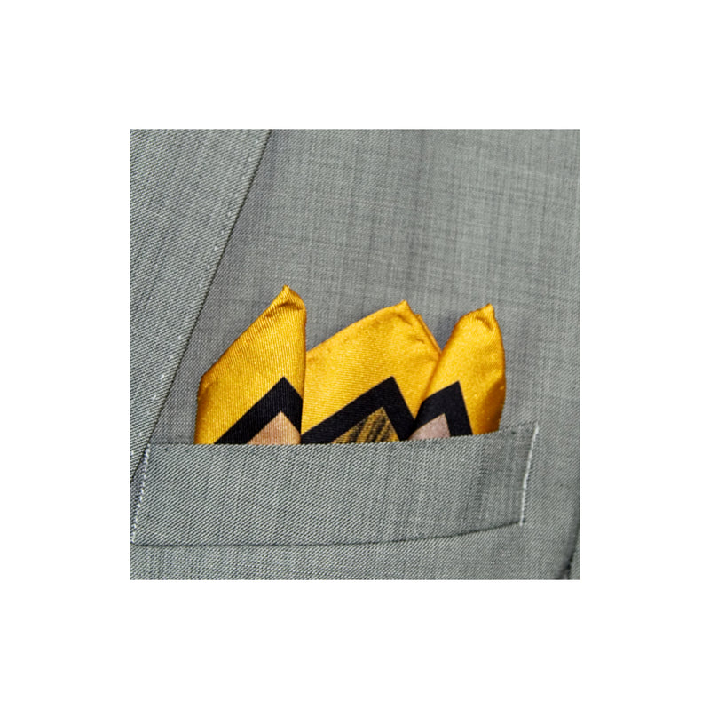 Yellow border silk pocket square with abstract pattern in black and grey shown in a grey suit